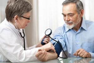 doctor measures blood pressure